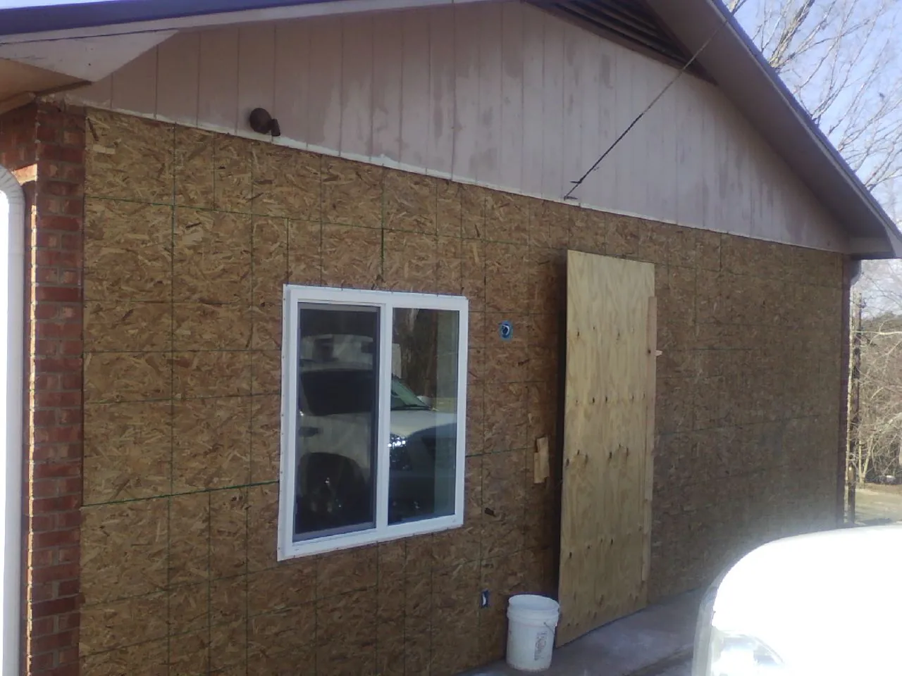 OSB sheathing on a garage addition wall before siding in Verona